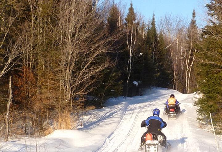 Snowmobilers enjoy a N.H. trail : 50,000 to 60,000 snowmobile enthusiasts take to the trails every year