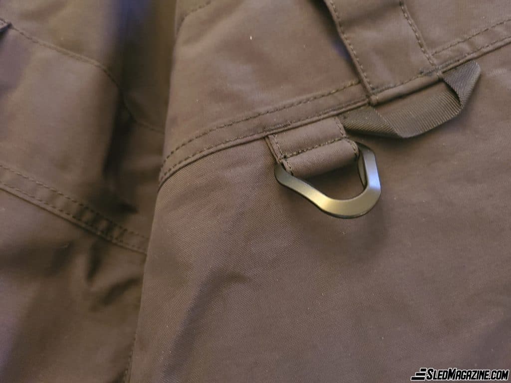 Small practical item: A D-ring on the overalls to attach the snowmobile's emergency stop cable.