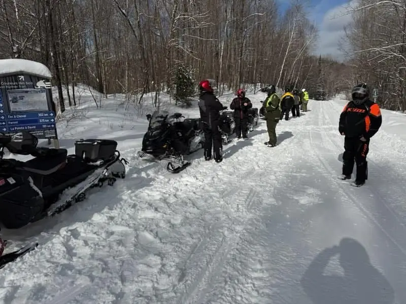 Trail officers intervening with snowmobilers