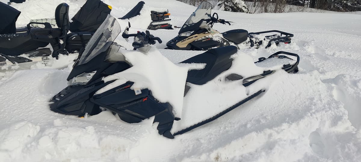 We have to clear the snow off our snowmobiles