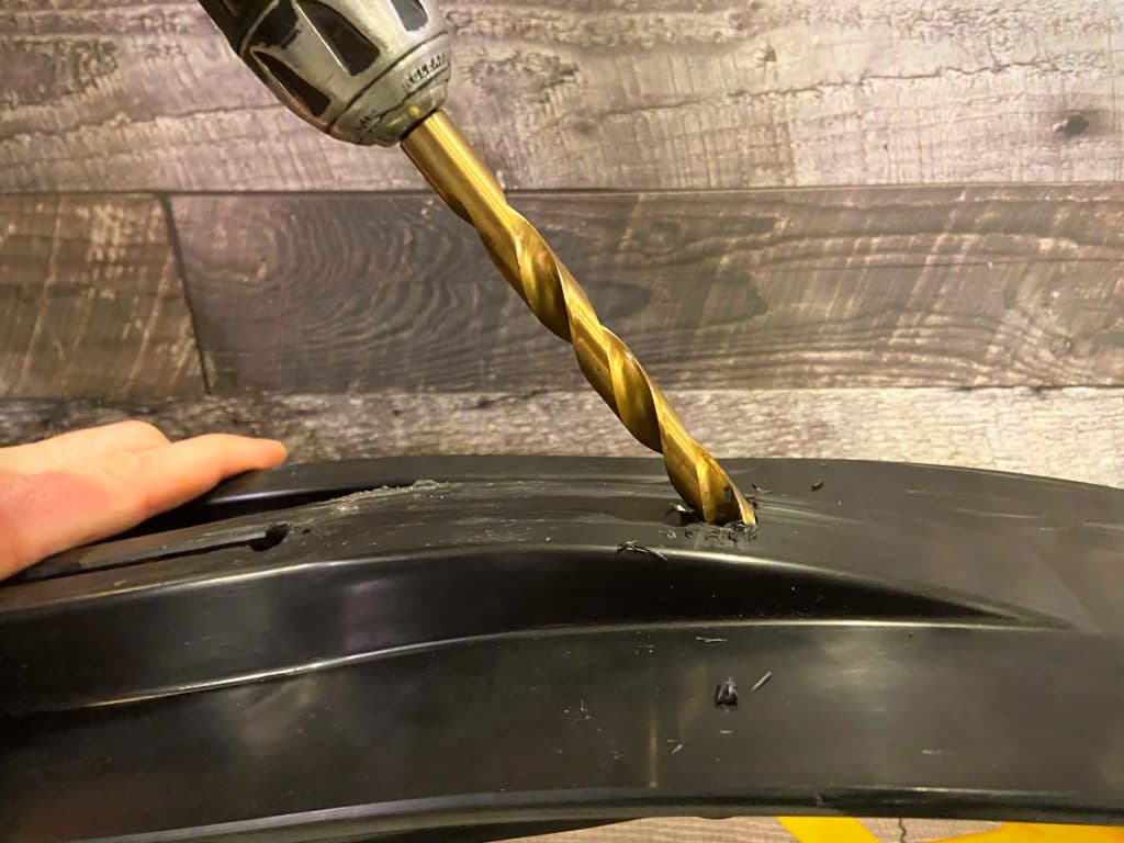 step 2 for installing Snowtrackers: Drill holes at the bottom of the skis