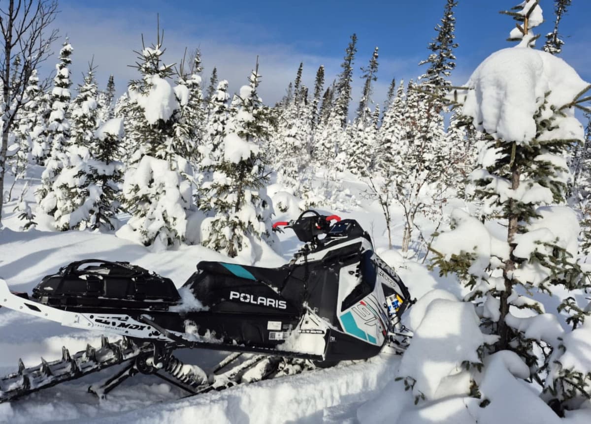 Polaris Patriot 9R RMK Khaos Slash 2025 snowmobile in a snowy forest