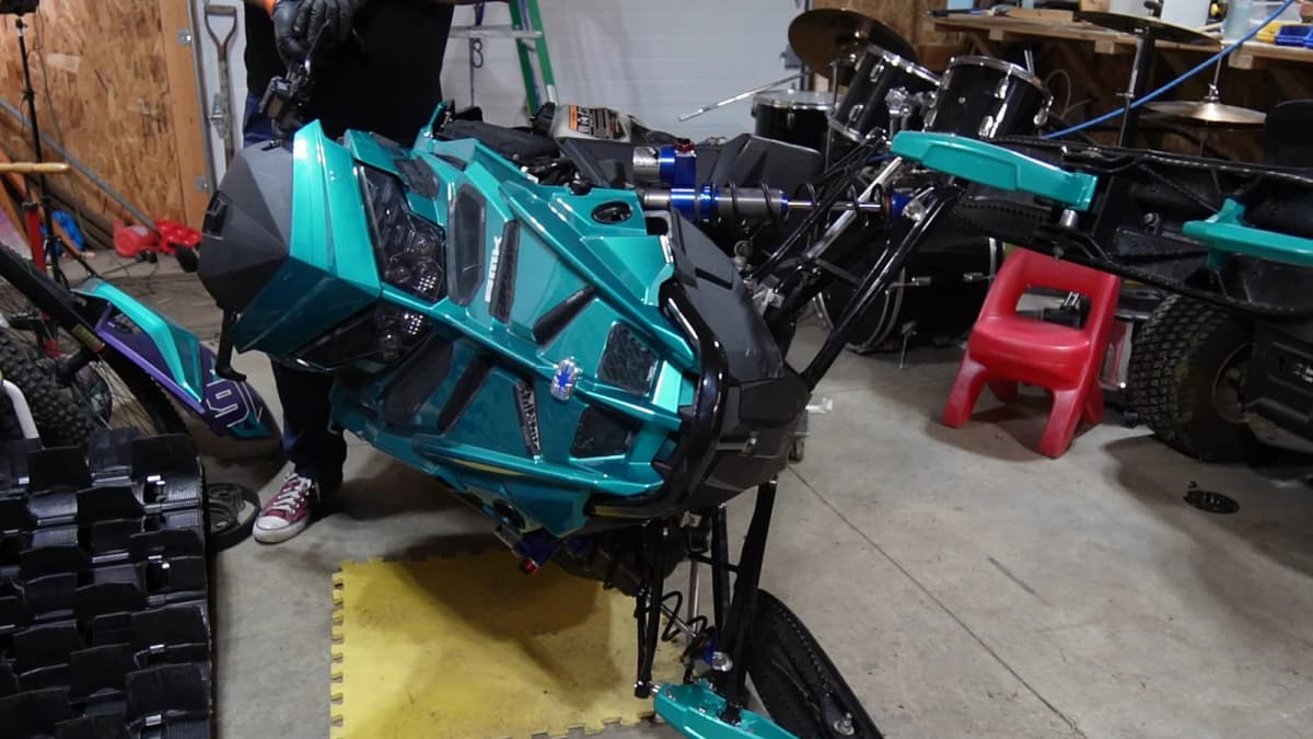 Snowmobile positioned on its side